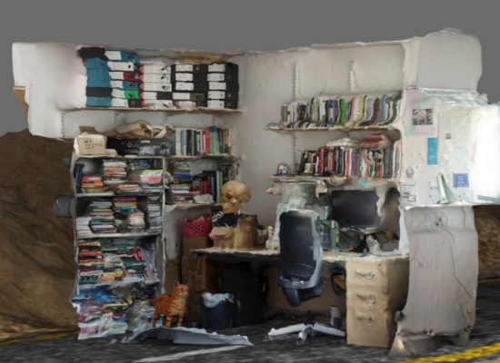 A distorted 3D-rendered scene shows a cluttered office corner with shelves full of books, binders, and boxes, along with a desk holding a computer and chair. Additional details include a skull model, a small orange cat figure, and various papers scattered throughout the space.