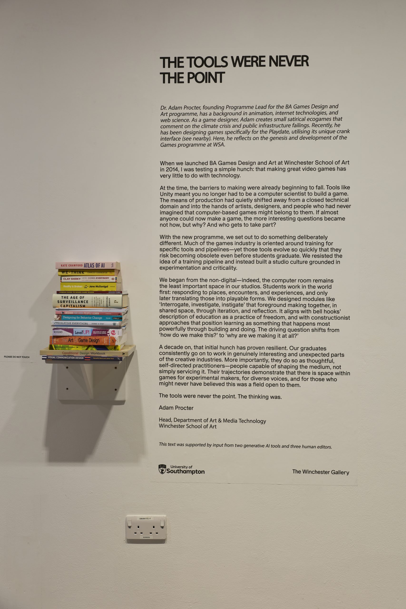 A wall display features a large text panel titled “The Tools Were Never the Point” alongside a small shelf stacked with books. The panel includes a long paragraph of explanatory text and University of Southampton branding at the bottom.