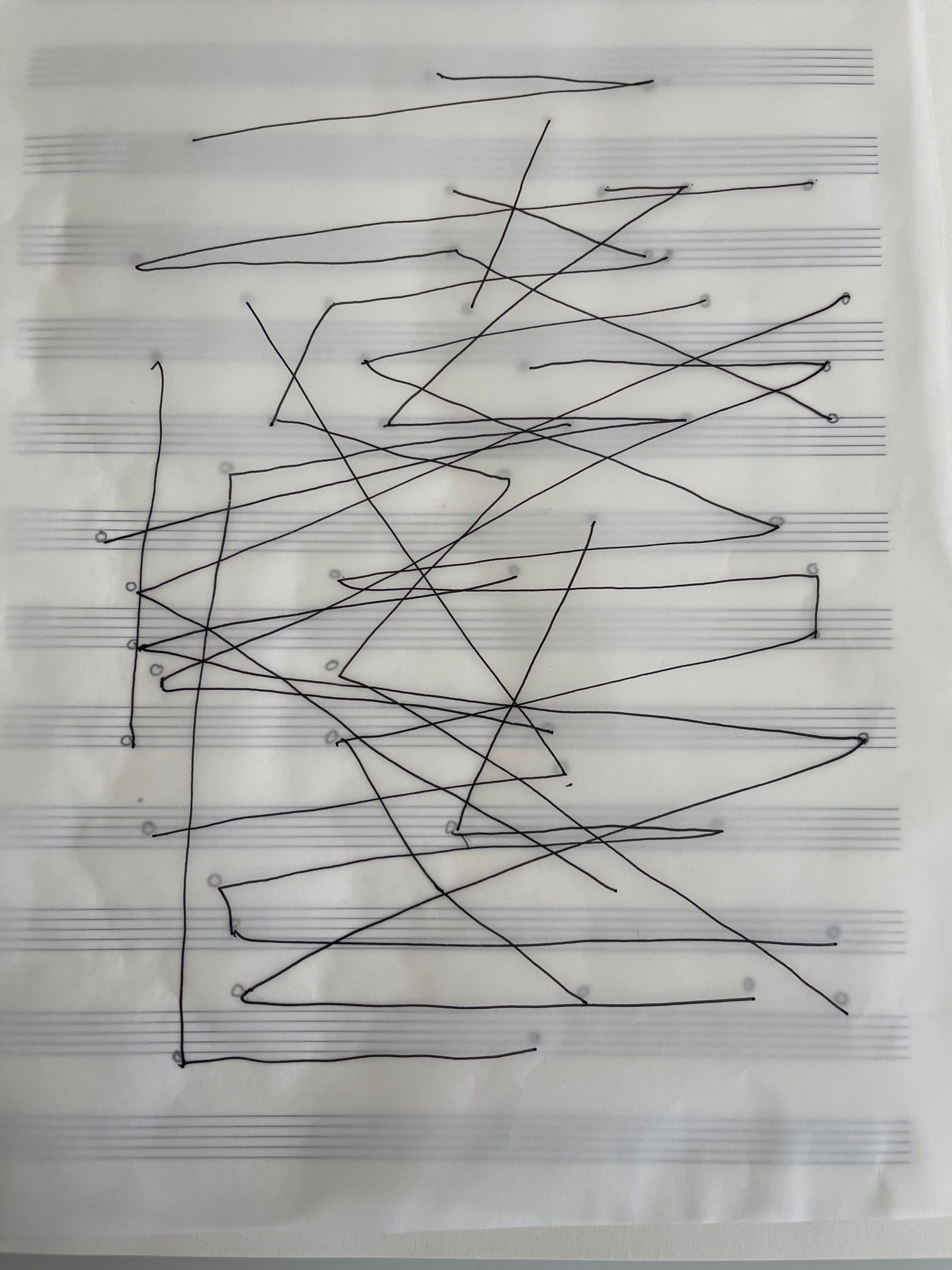Abstract line drawing on transparent paper over musical staves, with black lines crossing and intersecting to create a graphic score-like composition.